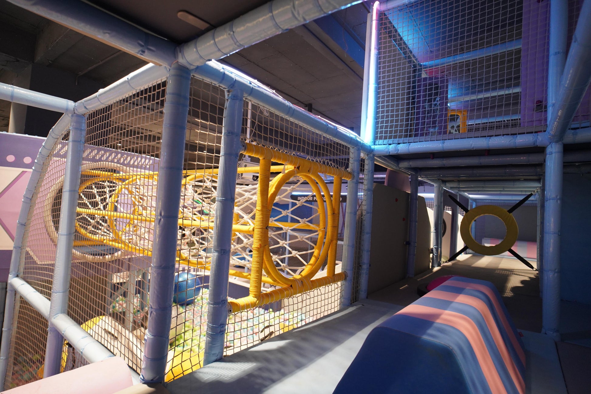 Children's indoor play area with colorful structures and slides.