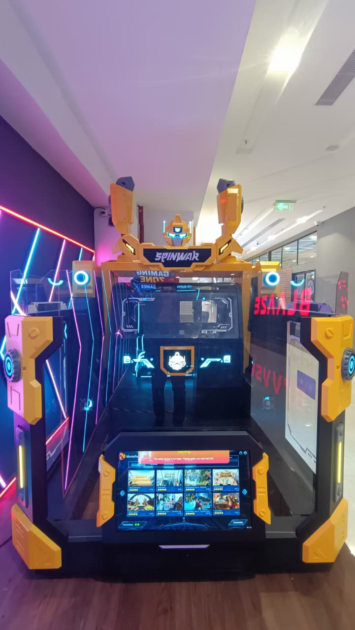 A bright yellow and black arcade game with neon lights, displaying game options on a screen.