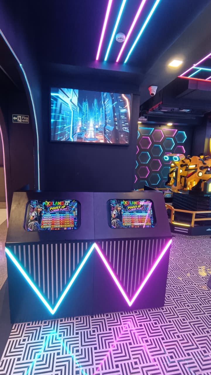 Two arcade game machines with neon lights in a futuristic arcade.