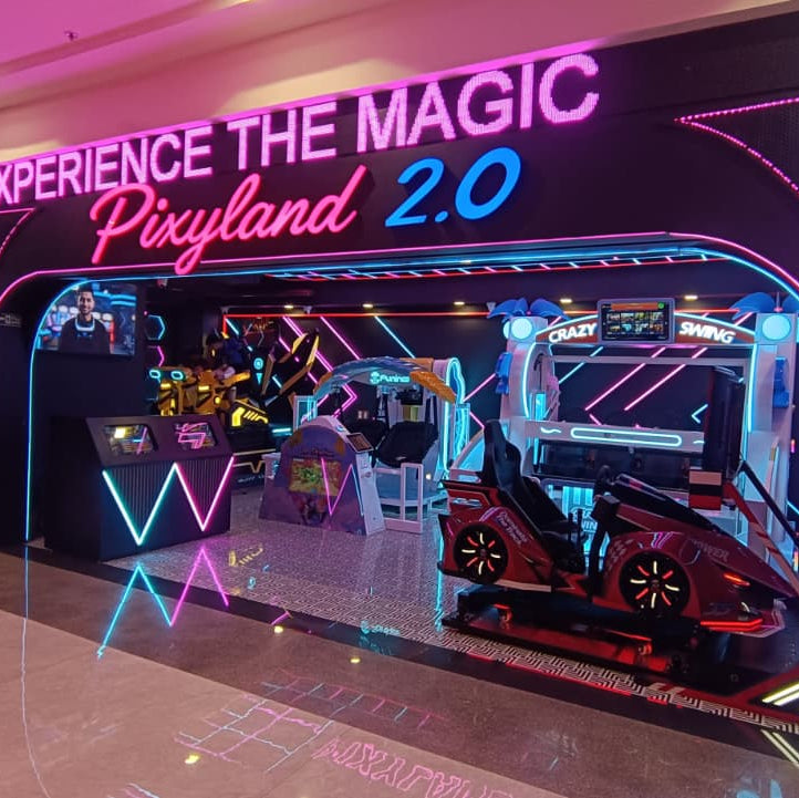 An arcade with neon lights and various game machines, including a red car-shaped simulator.
