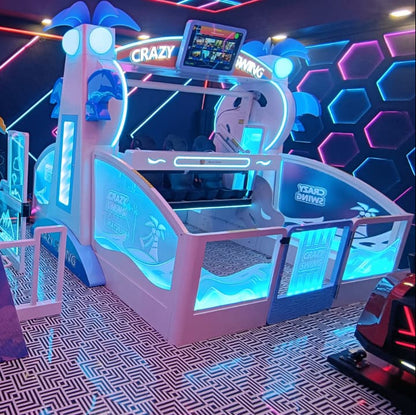 A brightly lit arcade ride with seats and a screen, likely for children or teens.