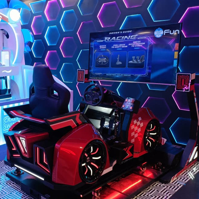 A racing arcade game with a red car seat and a large screen displaying game instructions.