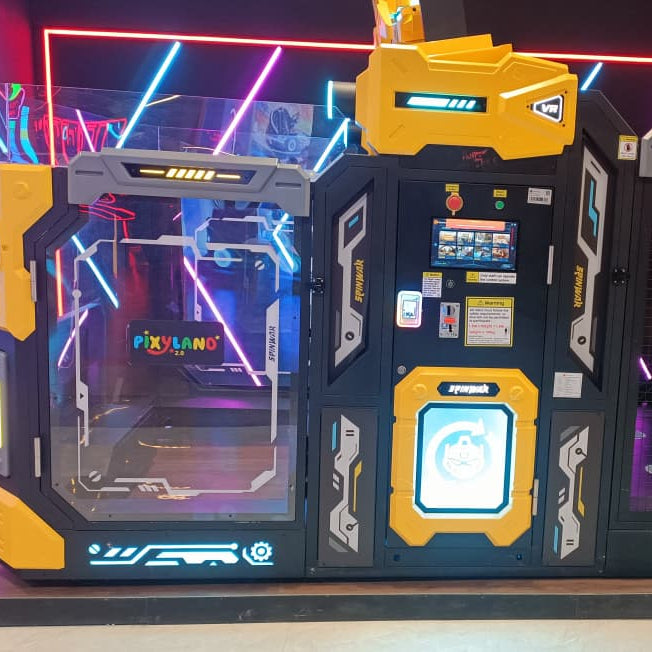 A brightly lit arcade game with yellow and black accents, featuring a screen and a VR headset.