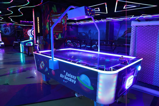 Neon-lit Galaxy Air Hockey table with vibrant colors and glowing edges inside Play Mania arcade at Ocus Medley Gurgaon