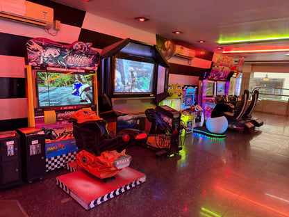 Arcade with racing and shooting games, featuring a motorcycle simulator.