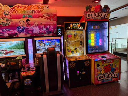 Arcade machines with racing and prize games, including "Connection PK" and "Color Boyz 5 Heroes."
