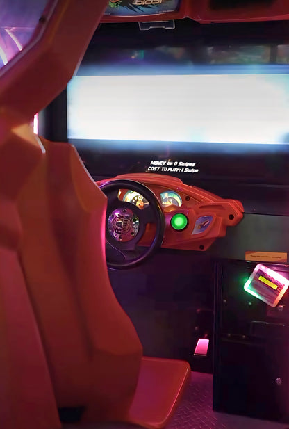 Arcade racing game with a steering wheel and dashboard.
