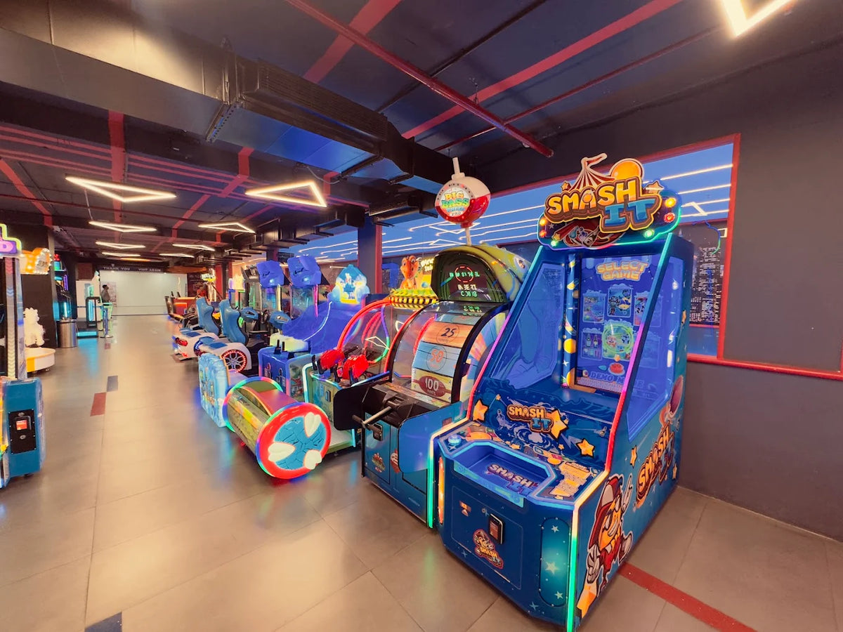 An arcade with rows of colorful, brightly lit video games, including a "Smash It" game.