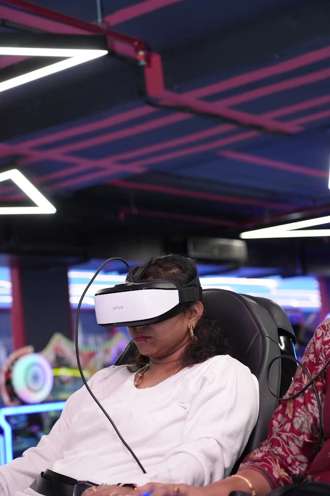 A woman in a VR headset plays a game in a dimly lit arcade with neon lights.