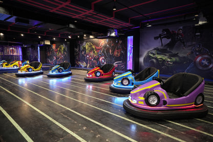 Bumper cars with superhero murals in an amusement park.