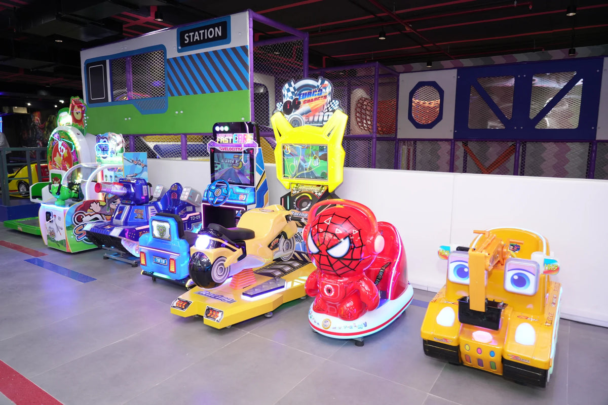 Children's arcade with colorful racing games and ride-on toys.
