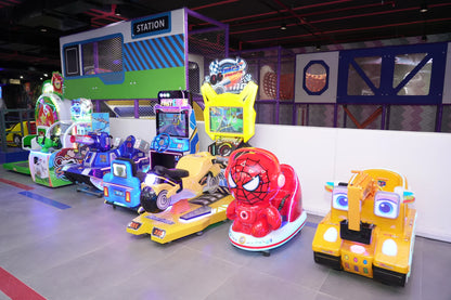 Children's arcade with colorful racing games and ride-on toys.