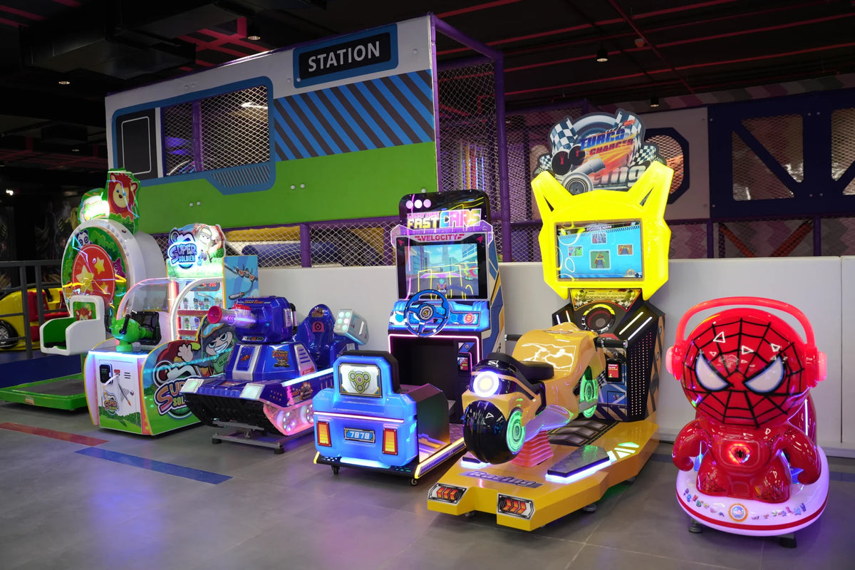 Arcade with various kid-friendly rides and games, including a Spiderman-themed ride and racing simulators.