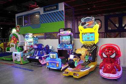 Arcade with various kid-friendly rides and games, including a Spiderman-themed ride and racing simulators.