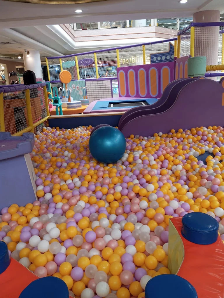A colorful ball pit filled with children's toys and playground equipment.