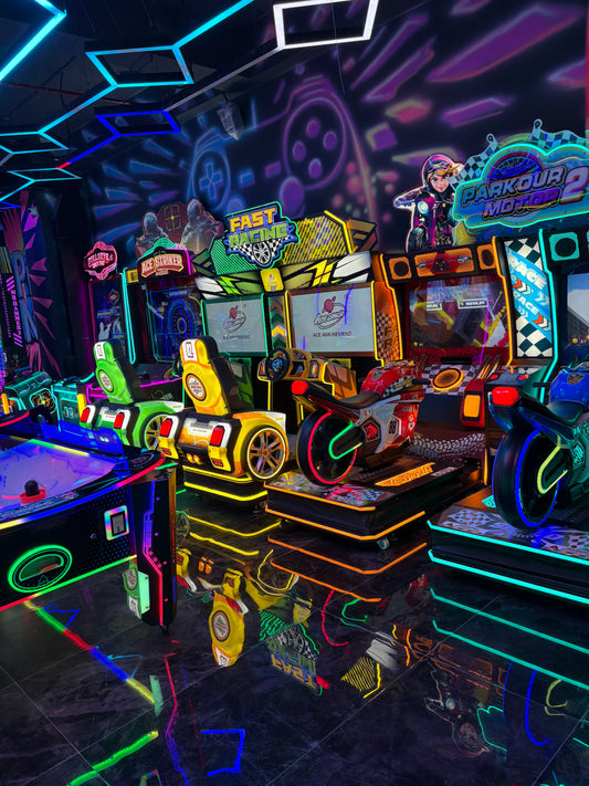 Arcade with neon lights and racing games.