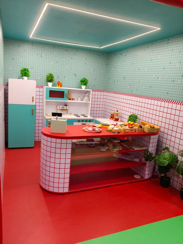 A colorful, toy kitchen with food items on display.