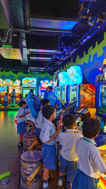 Children playing interactive video shooting games in a neon-lit arcade at Sky Gamer Sector 12 Faridabad