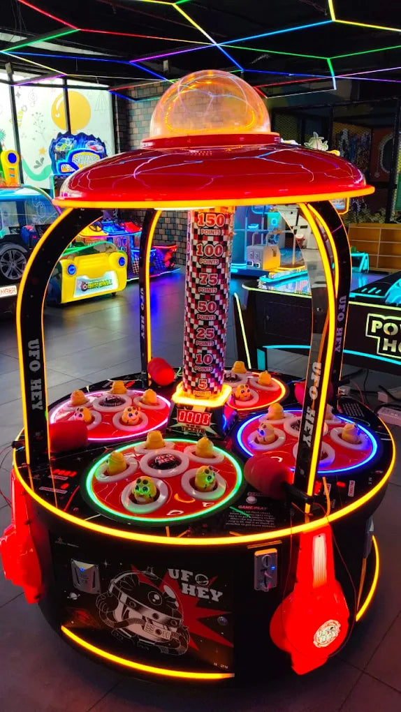 Brightly lit UFO Hey arcade game with colorful moles surrounded by neon lights at Sky Gamer Sector 12 Faridabad