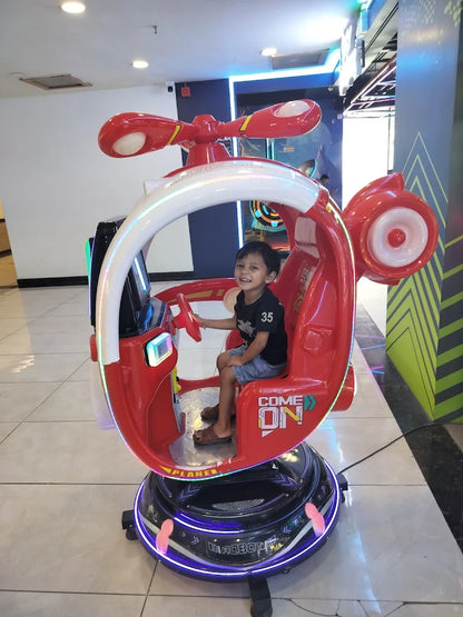 Child enjoying a ride in a red helicopter arcade game with colorful lights at Sky Gamer Sector 12 Faridabad