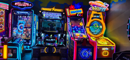 Row of vibrant neon-lit arcade machines featuring Thunder Attack and Soul Ramp games at Sector 12 Faridabad play zone