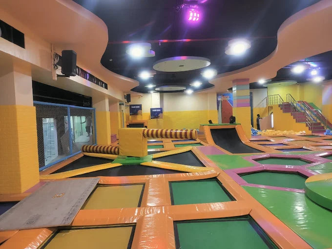 Wide view of indoor trampoline zones with interconnected bouncing mats and padded barriers at SkyJumper Kids trampoline park Gurgaon