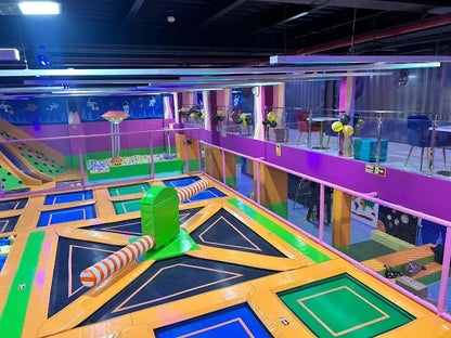 Spacious indoor trampoline area with vibrant colors and soft play structures at a kids trampoline park in Gurgaon