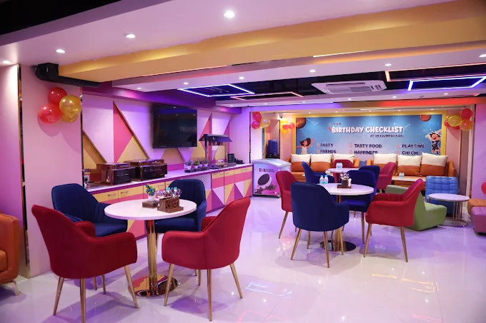 Bright indoor party room with colorful chairs and festive balloons at a kids trampoline park in Gurgaon