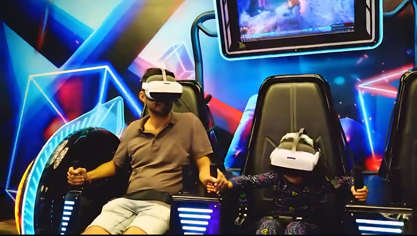 A man and a child in VR headsets sit in futuristic chairs, holding controllers. They are in a brightly lit arcade with neon blue and pink accents.