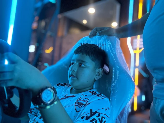 Young boy focused on racing game seated in illuminated gaming chair at Skycrest Gaming Cafe Sector 79 Faridabad