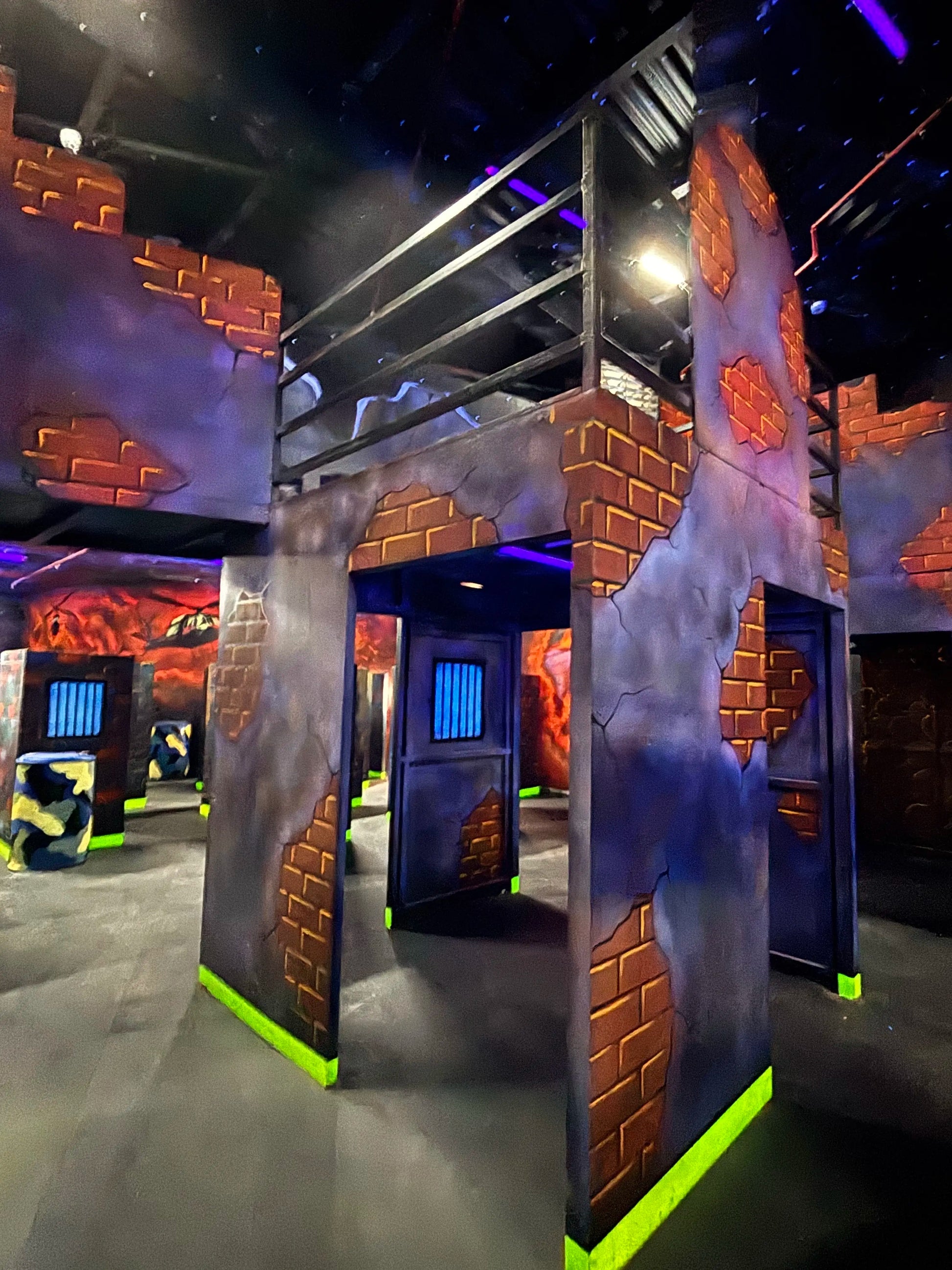 Laser Tag arena with colorful walls and floor, featuring a large ice sculpture.