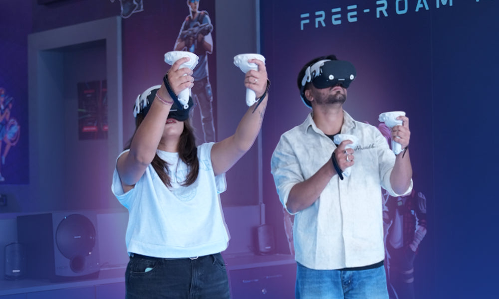 Two young adults wearing VR headsets play a game, holding controllers.