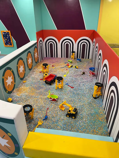 A colorful ball pit filled with toys for young children.