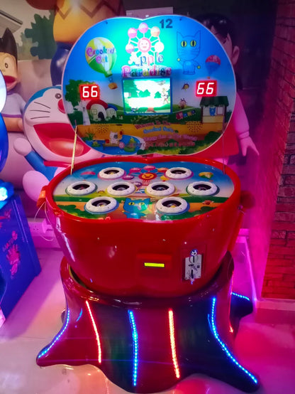 A red arcade game with a colorful screen and multiple holes, likely for children to play.
