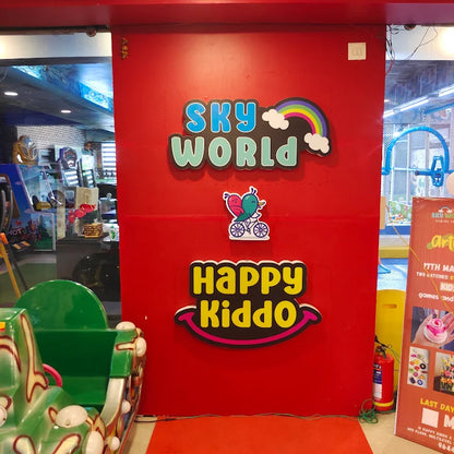 A red wall with "Sky World" and "Happy Kiddo" signs, featuring a cartoon bird on a bike.