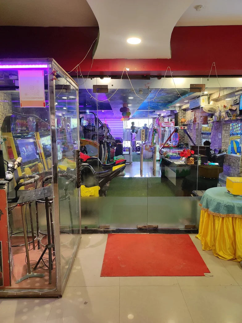 An arcade with various games and people playing.