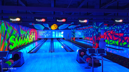 A brightly lit bowling alley with neon colors and a "Smash" logo.