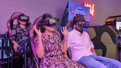 Adults wearing VR headsets in a gaming arcade, experiencing a virtual reality simulation.