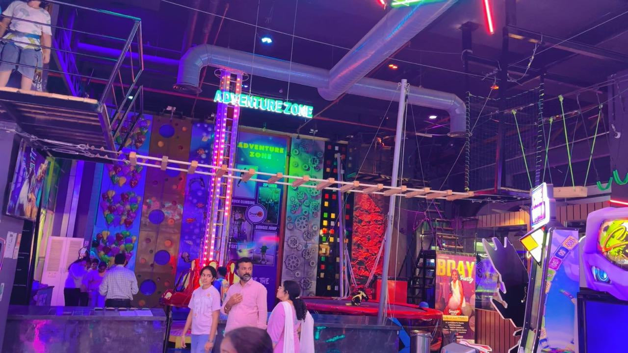 People enjoy an indoor adventure park with climbing walls and obstacle courses.