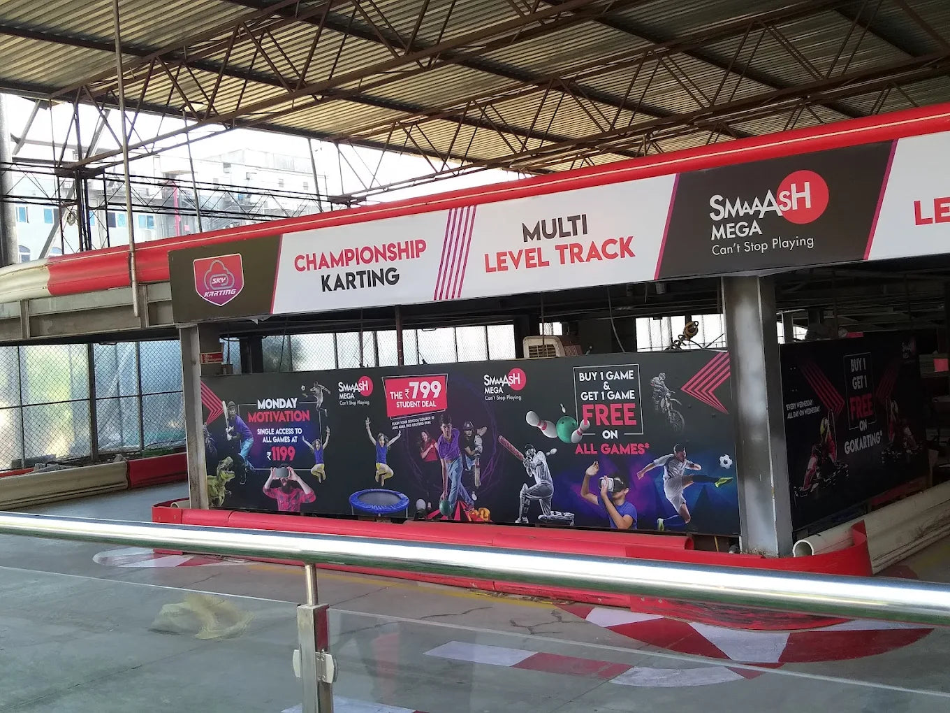A go-kart track with signs advertising "Championship Karting" and "Multi Level Track" for young people.