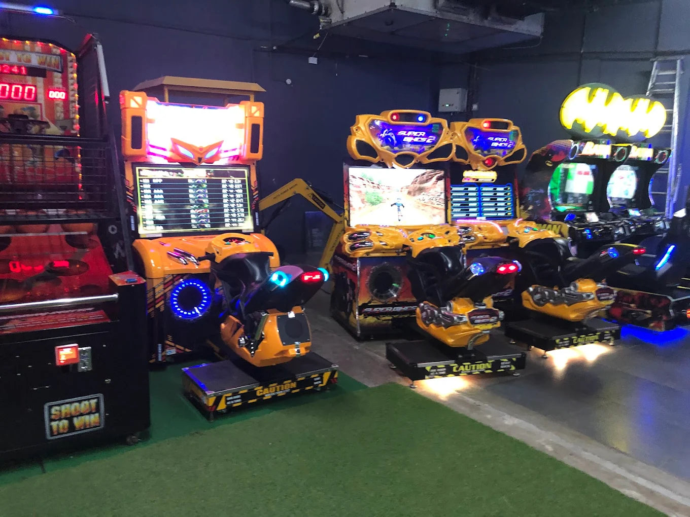 Arcade with multiple racing and shooting games, including motorcycle simulators.
