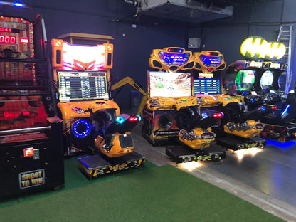 Arcade with multiple racing and shooting games, including motorcycle simulators.