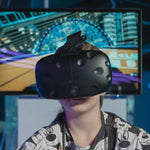 Person wearing a VR headset in front of a colorful screen