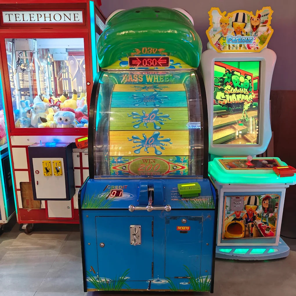 Arcade games, including a frog-themed wheel game and a "Parkour" game, are displayed in an entertainment center.