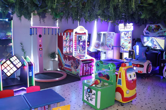 Children's play area with colorful arcade machines and toys.