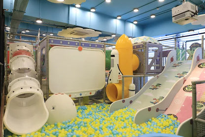 Children's indoor play area with slides and colorful ball pit.