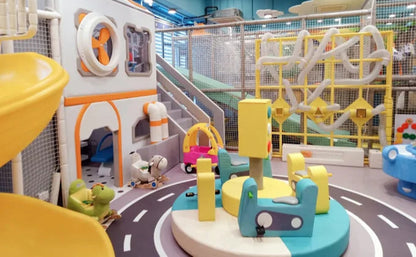 Colorful indoor playground with various toys and structures.