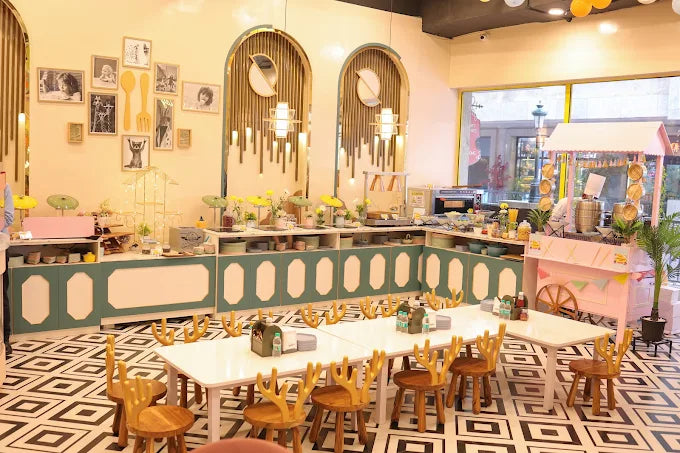 Bright and charming kids’ dining area with deer-themed wooden chairs and pastel decor at indoor play space in Gurugram