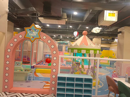 Indoor kids’ play area featuring a pastel-colored carousel structure and pink arch entrance at Tooney Tales Gurugram