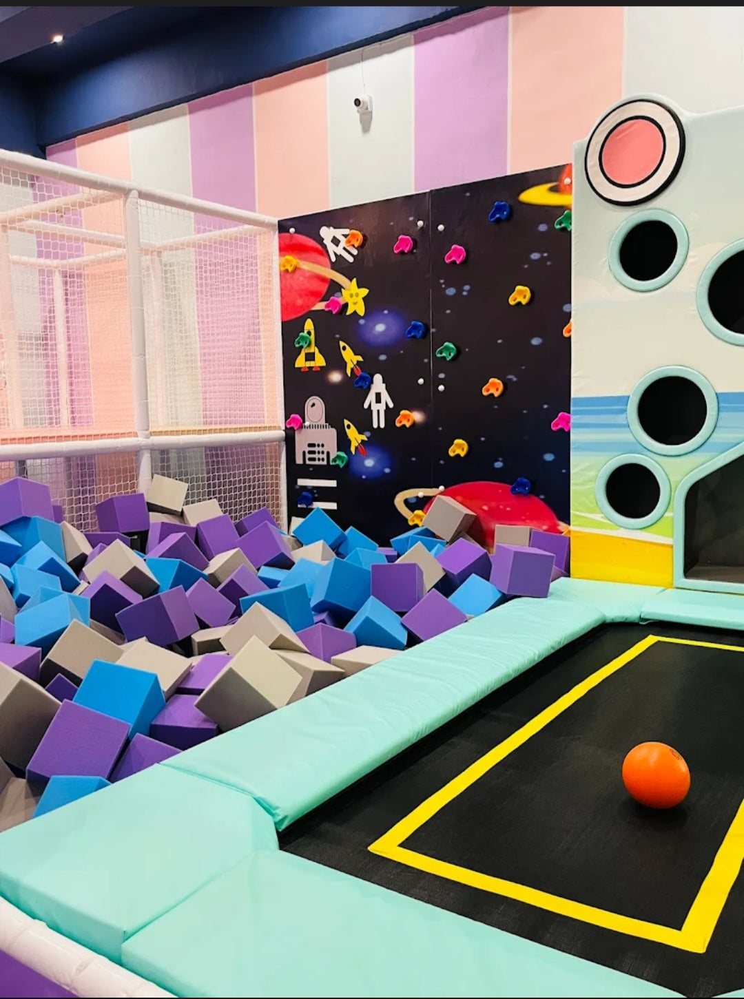Children's play area with colorful foam blocks and a climbing wall.